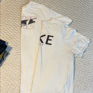 Two white Nike shirts
